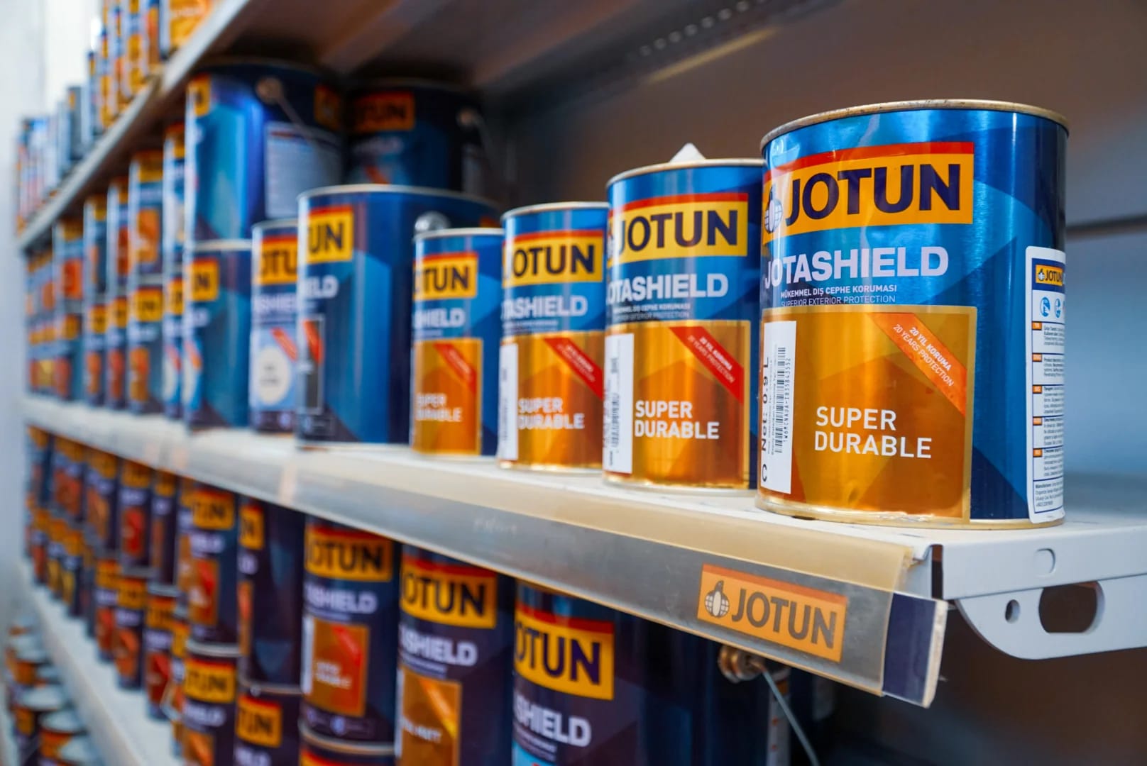Jotun Jotashield paint cans arranged on a store shelf